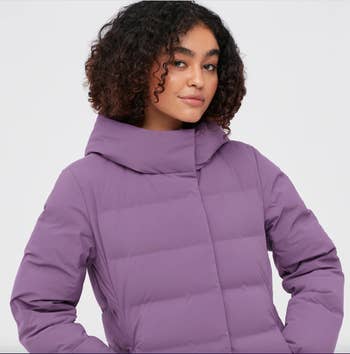 model wearing purple puffer coat