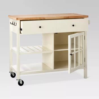 Image of off-white kitchen island with door open