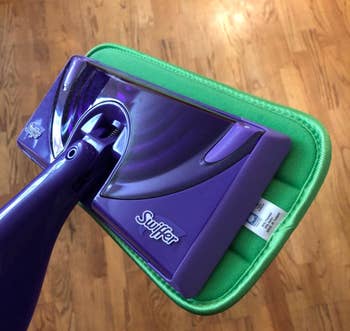 Close-up of a Swiffer mop with a reusable pad attached to it