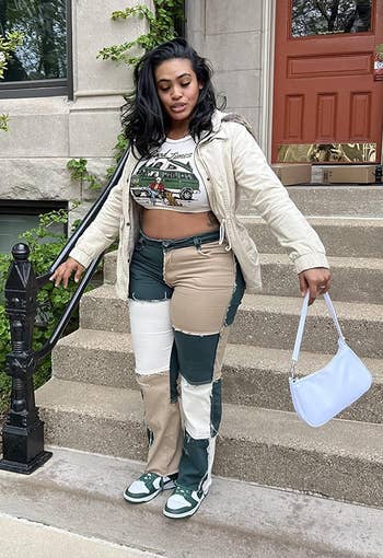 reviewer wearing the patchwork jeans successful greenish and white