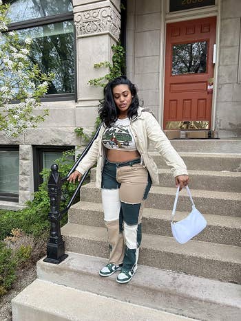reviewer wearing the patchwork jeans in green and white