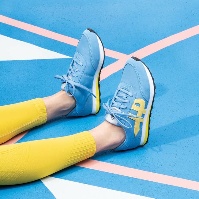 light blue sneakers with yellow swoopy h logo 