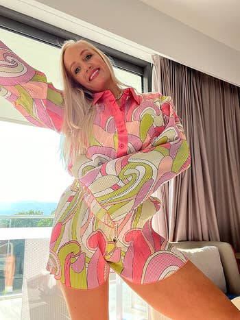 reviewer  wearing the set in printed pink, purple, and green