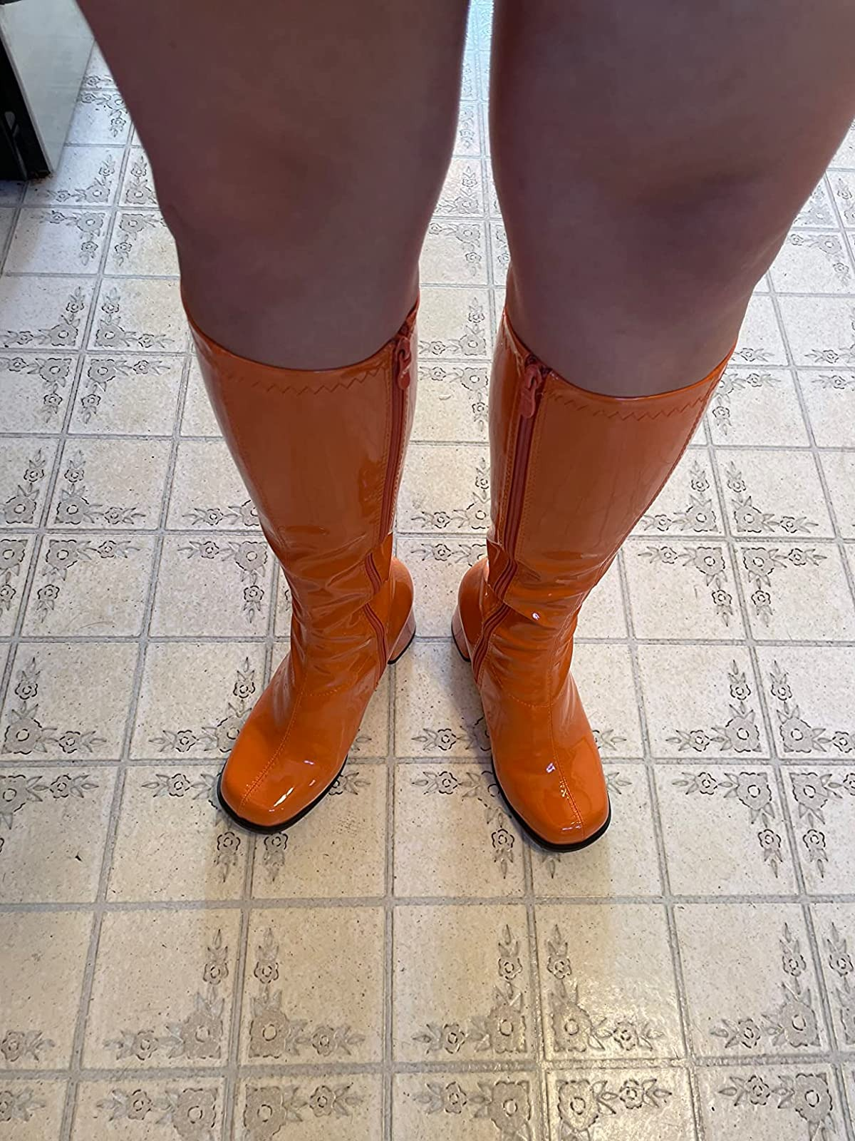 reviewer showing how the boots fit after using the shoe stretch spray