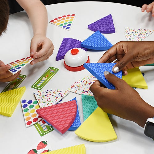 Hands on table playing cake game