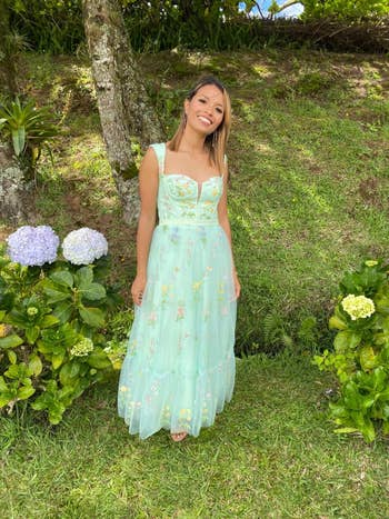 a reviewer in the green floral dress