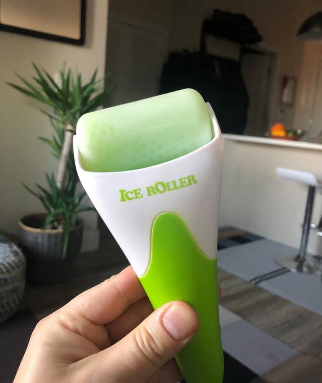 Reviewer holding an the green ice roller