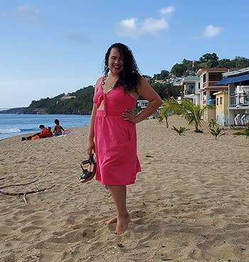 Reviewer wearing hot pink midi dress with button down skirt and tie front cutout top on the beach