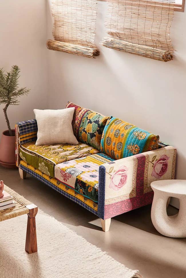 loveseat with two seat cushions, two back cushions, and arm rests from the frame. the fabrics are all unique to every piece, with miss-matched patchwork fabrics. 