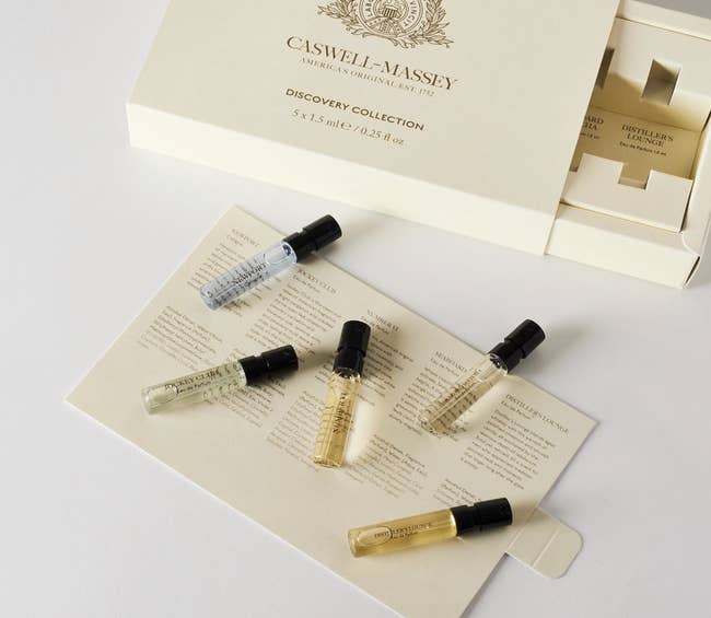 Five tiny perfume vials from Caswell-Massey Discovery Collection connected a paper with fragrance descriptions