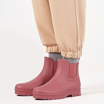 Model in a pair of pink ankle rubber boots 