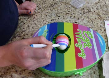 reviewer using marker to make stripes around spinning egg