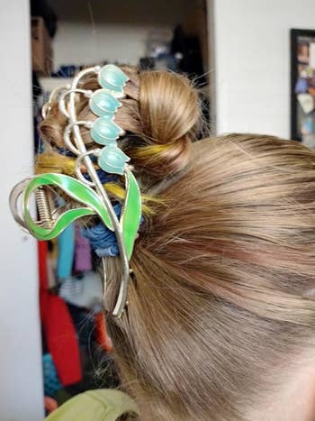Hair styled successful  a bun with an ornate decorative vale  of lily hairpin