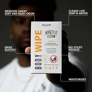 Person holding a Hustle Clean body wipe package