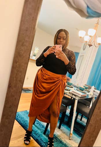 reviewer wearing the skirt in orange