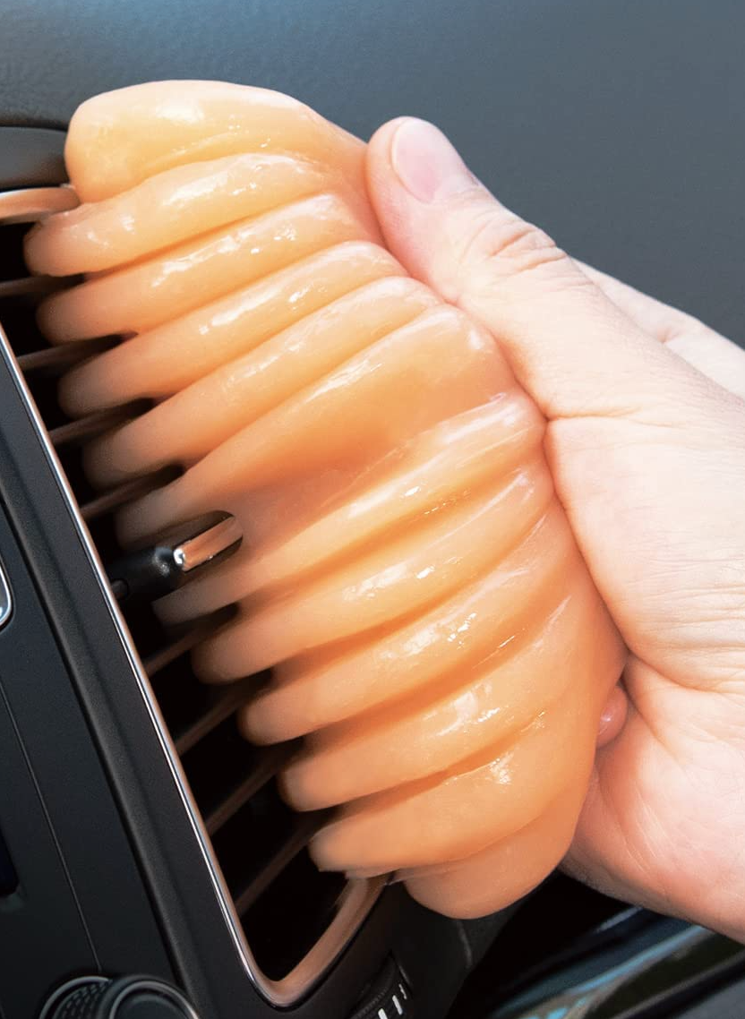 detailing putty being used to clean air vents in car ac