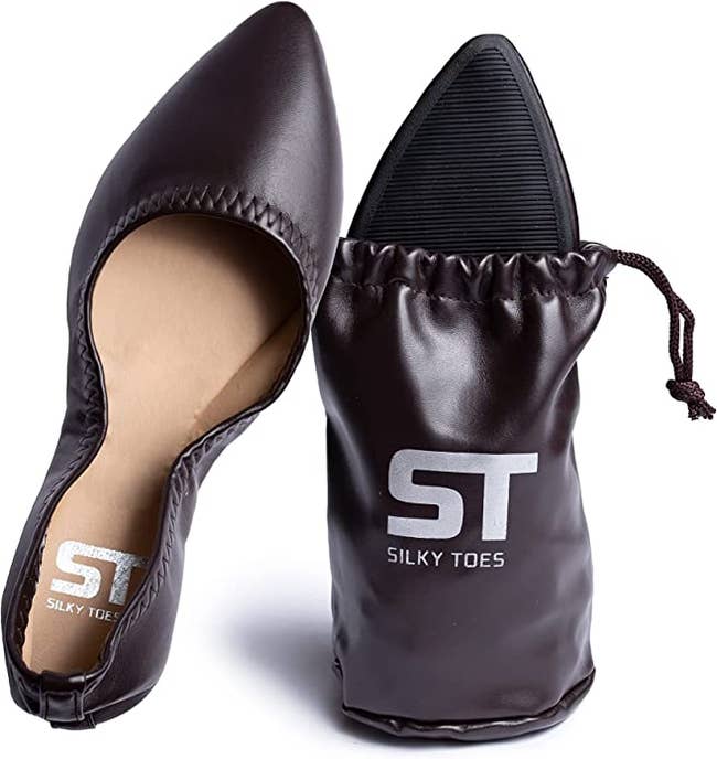 black pointed-toe flat next to the bag it folds up into