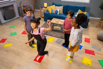 Children playing a crippled  connected  a colorful level  mat successful  a surviving  room, smiling and interacting energetically