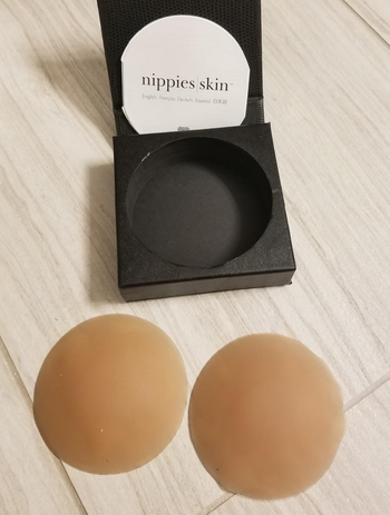a reviewer photo of the nipple covers and storage box 