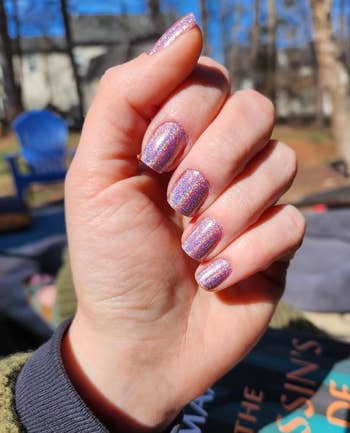 reviewers nails with pinkish and purple holographic glittery nails