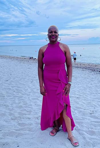 reviewer in the magenta long dress on a beach