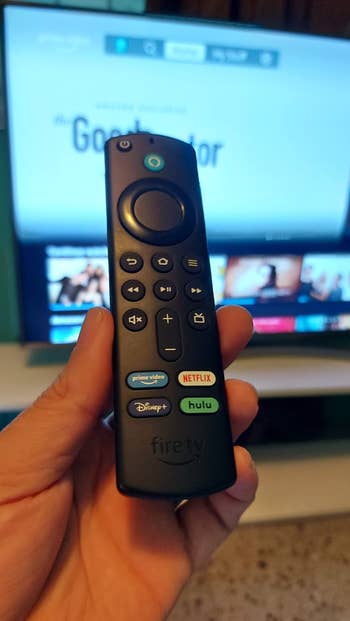 Reviewer holding fire tv remote stick