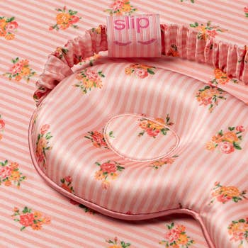 Silk slumber disguise with floral and striped plan connected matching cloth background, featuring the marque logo