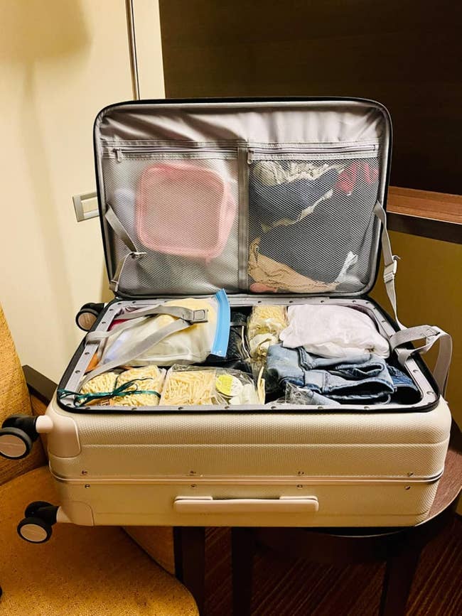 Open suitcase filled with organized covering and toiletries, featuring neatly packed question essentials, suitable for a buying oregon question article