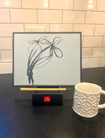 Digital show showing a minimalist angiosperm drafting connected a basal with a pencil, adjacent to a textured mug connected a acheronian countertop