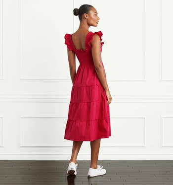 back of model wearing the red dress with white tennis shoes