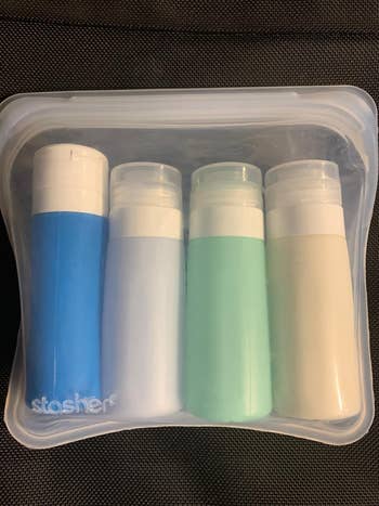 a reviewer photo of travel toiletries inside the reusable bag 