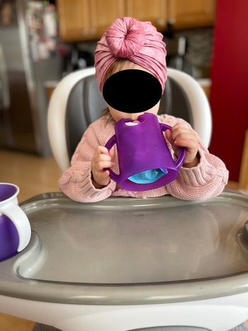 a reviewer's child using the pouch holder