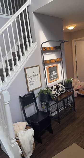 a review photo of the entry way organizer on the side of a stairway