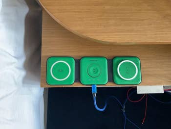 a foldable charger on a table for charging three devices