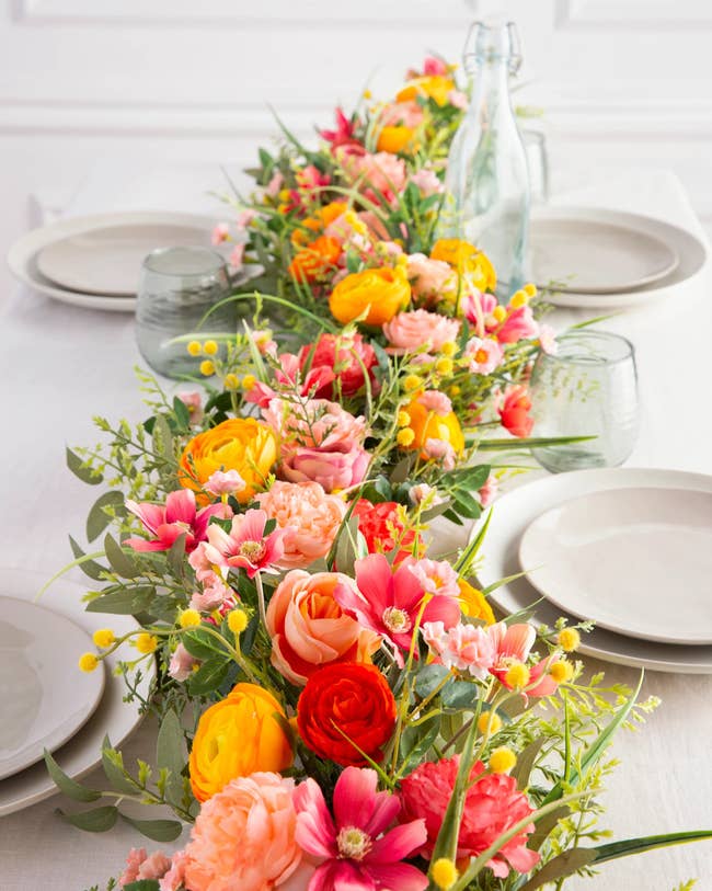 Floral centerpiece on a dining table with plates and glasses, ideal for home decor inspiration
