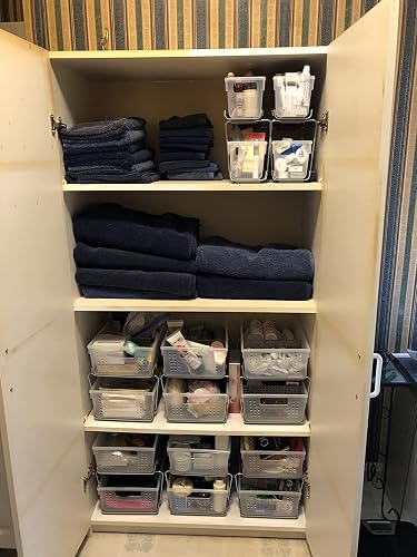 Organized bath  closet with towels and wide   bins storing toiletries and cleaning supplies connected  shelves
