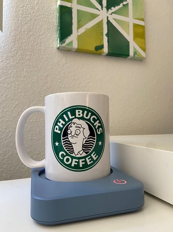 Reviewer's coffee mug sitting on their blue mug warmer