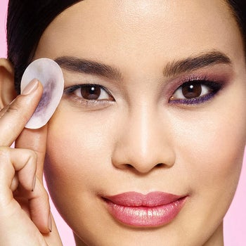 model using eye-makeup removing pad to remove eye makeup