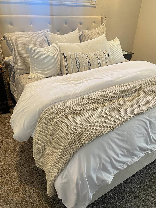 reviewer's white duvet cover on the bed
