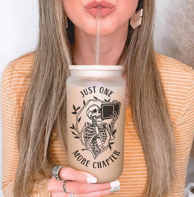 A model holding the cup that shows a skull reading