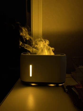 white humidifier with steam coming out of it