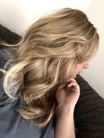 reviewer after removing headband curler to reveal bouncy curls