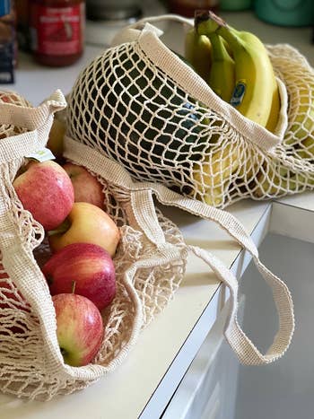 reviewer's two mesh bags full of produce on a counter