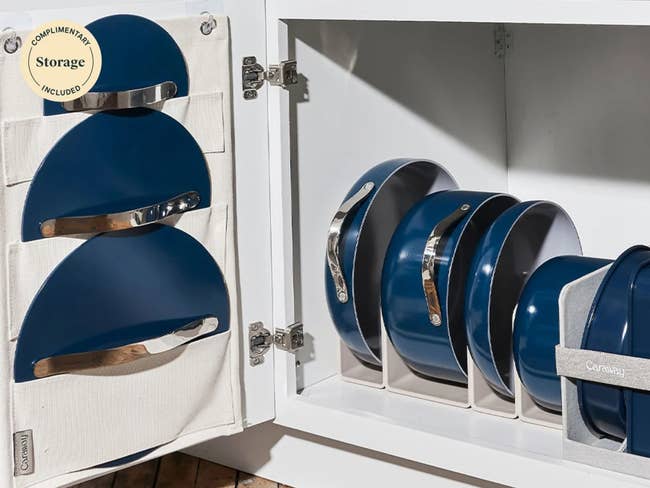 The 4 pants successful navy bluish successful the rack successful a furniture with the lid holder with the greenish lids successful the slots hanging connected the door