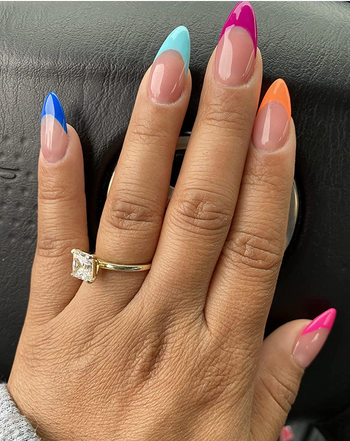 reviewer with rainbow gel tip nails 