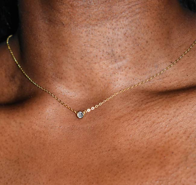 model in gold and clear stone collarbone length necklace
