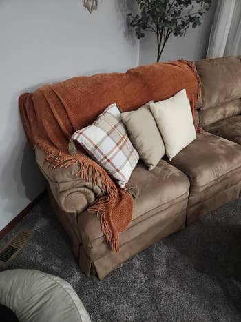 an orange chenille throw on a couch