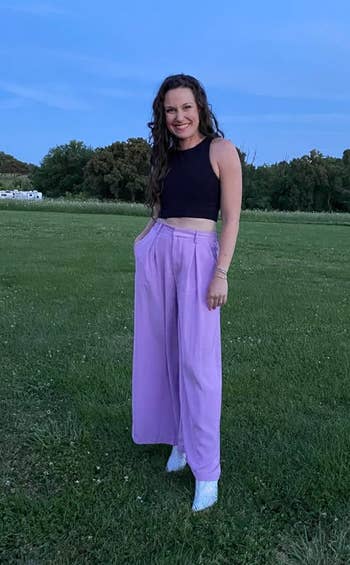 reviewer posing wearing the purple pants