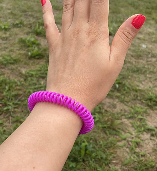 a reviewer wears the pink bracelet on their wrist