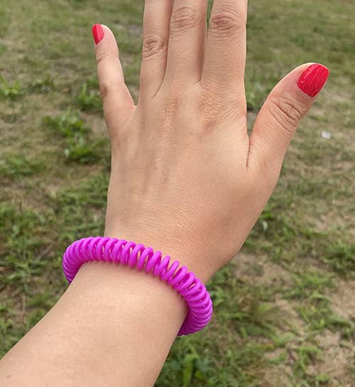 a reviewer wears the pink bracelet on their wrist
